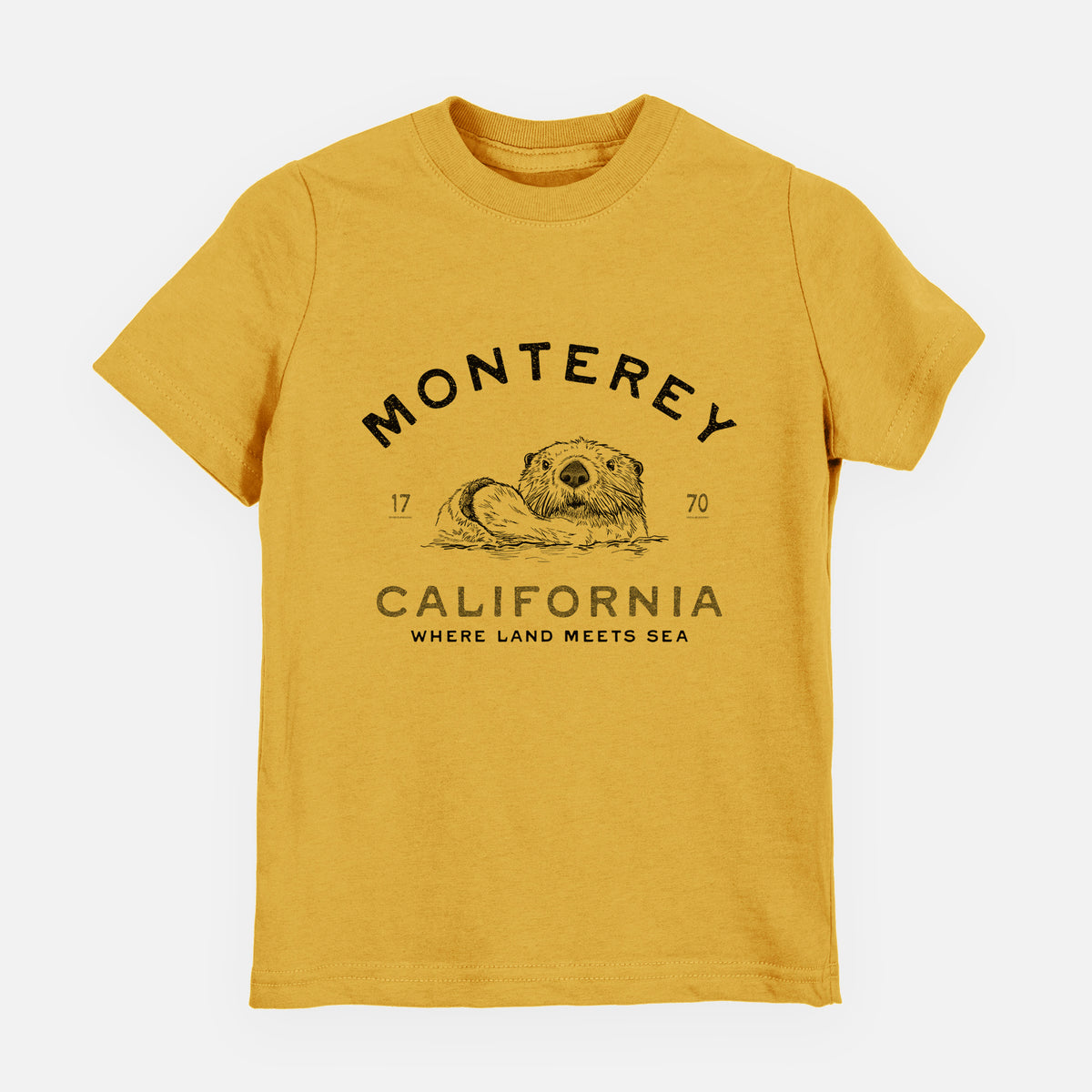 Honeycomb yellow youth t-shirt laid flat, printed with a black ink sea otter floating on its back, with the words Monterey California, 1770, Where Land Meets Sea.