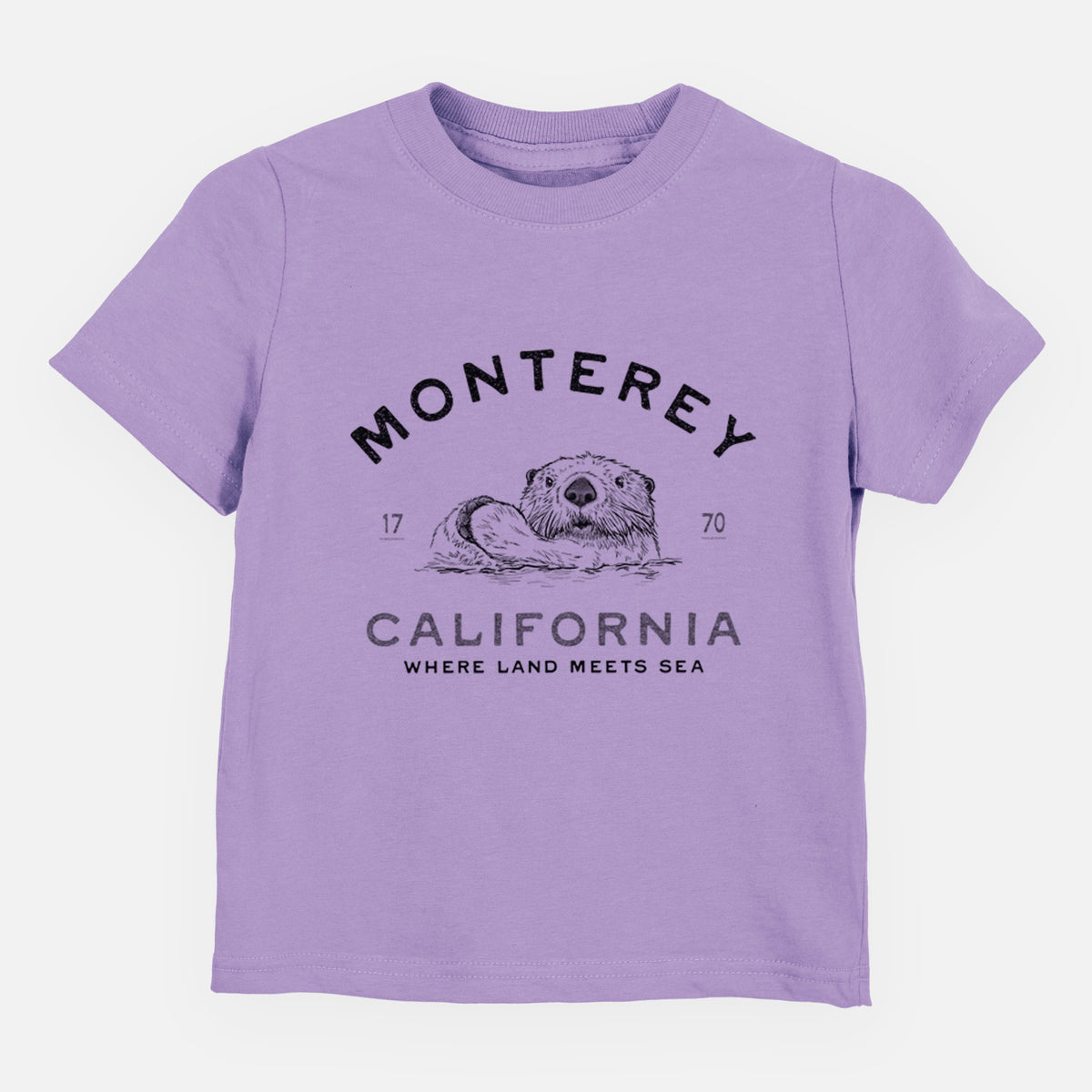 Lavender toddler t-shirt laid flat, printed with a black ink sea otter floating on its back, with the words Monterey California, 1770, Where Land Meets Sea.