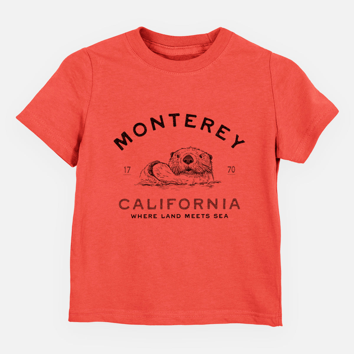 Passionfruit pink toddler t-shirt laid flat, printed with a black ink sea otter floating on its back, with the words Monterey California, 1770, Where Land Meets Sea.
