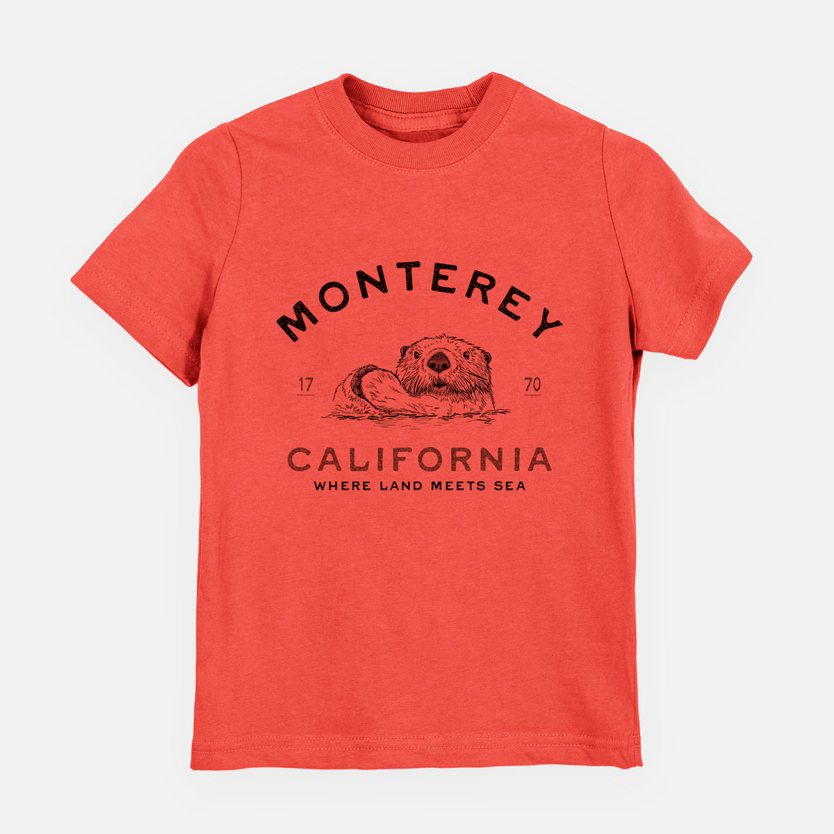 Passionfruit pink youth t-shirt laid flat, printed with a black ink sea otter floating on its back, with the words Monterey California, 1770, Where Land Meets Sea.