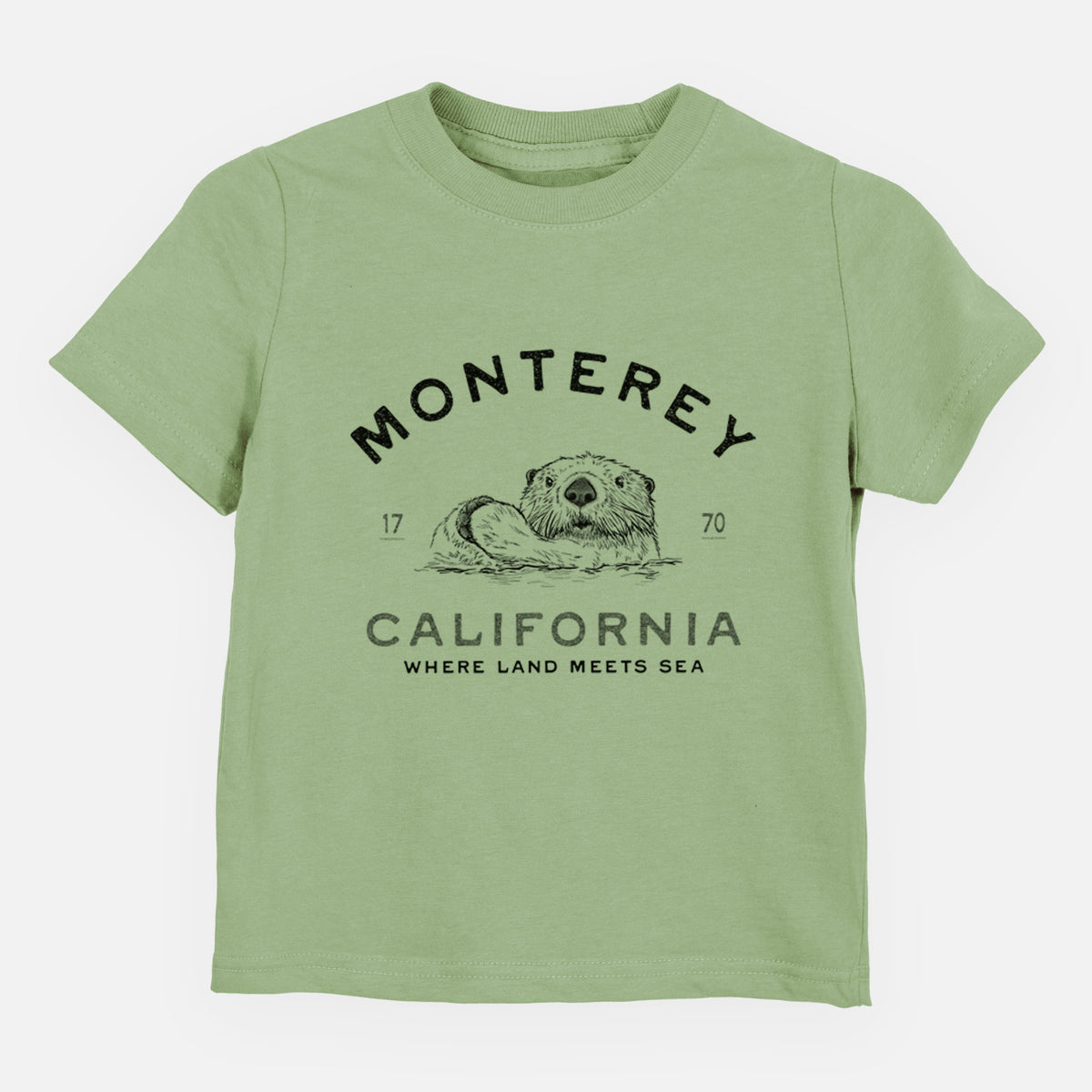 Sage green toddler t-shirt laid flat, printed with a black ink sea otter floating on its back, with the words Monterey California, 1770, Where Land Meets Sea.