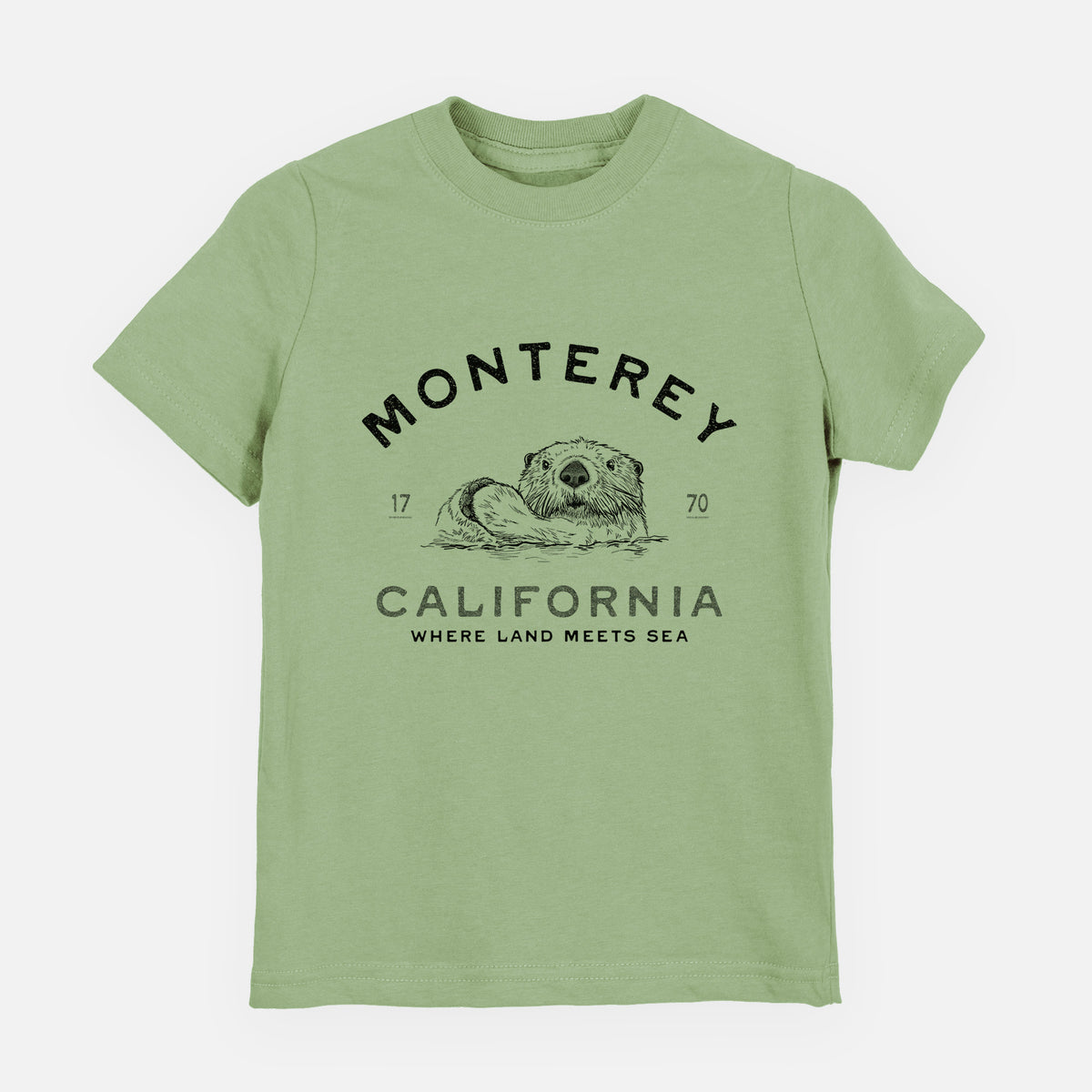 Sage green youth t-shirt laid flat, printed with a black ink sea otter floating on its back, with the words Monterey California, 1770, Where Land Meets Sea.