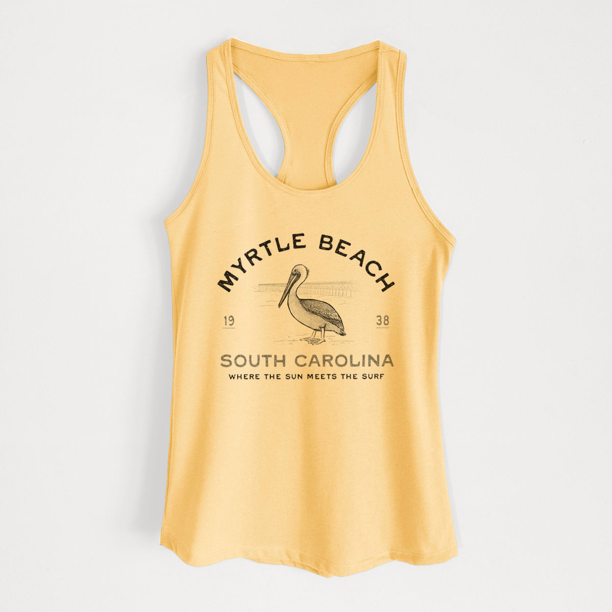 Banana cream women's racerback tank top laid flat, printed with a black ink pelican on a post with the words Myrtle Beach South Carolina, Where the Sun Meets the Surf.