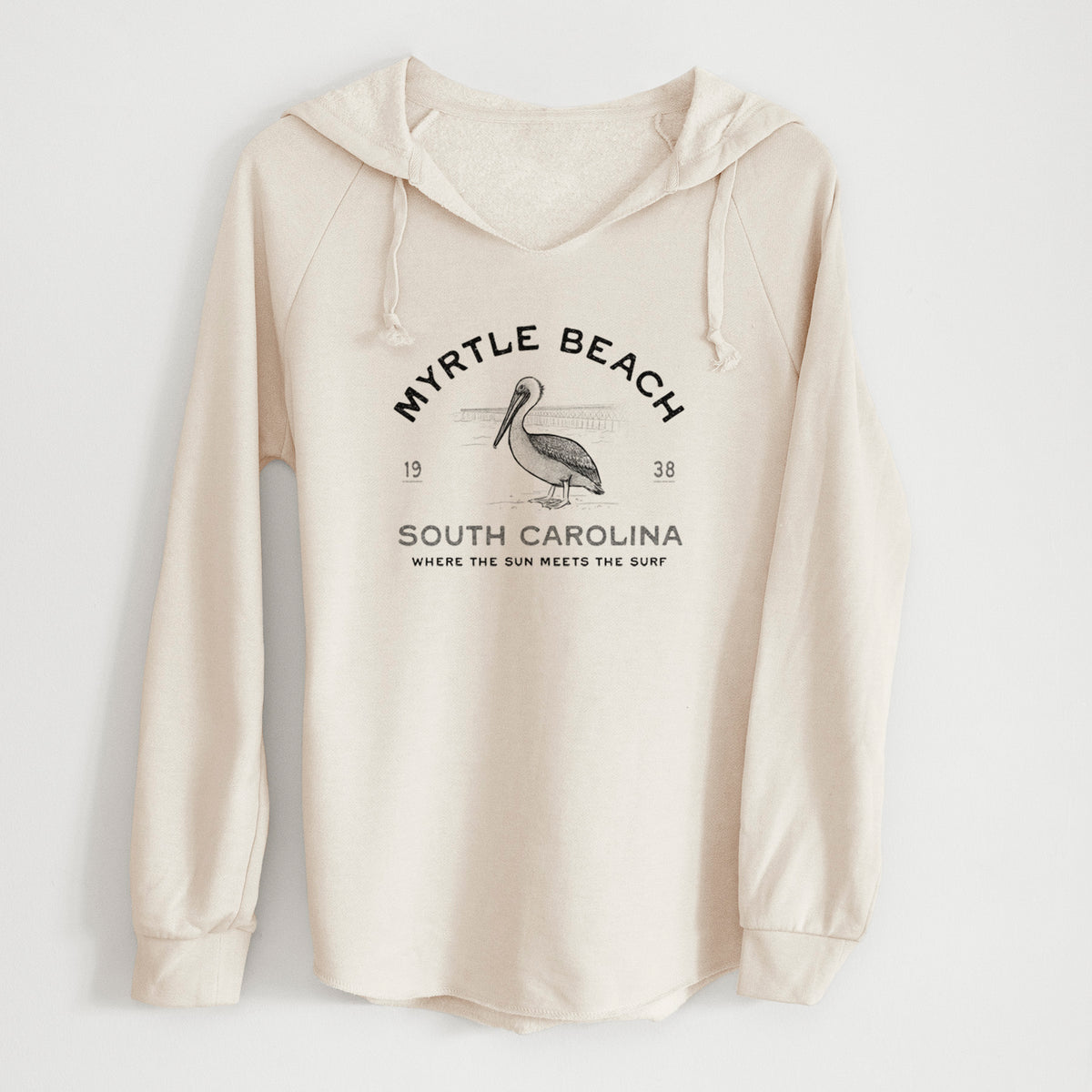 Bone cream women's Cali Wave hooded sweatshirt laid flat, printed with a black ink pelican on a post with the words Myrtle Beach South Carolina, Where the Sun Meets the Surf.