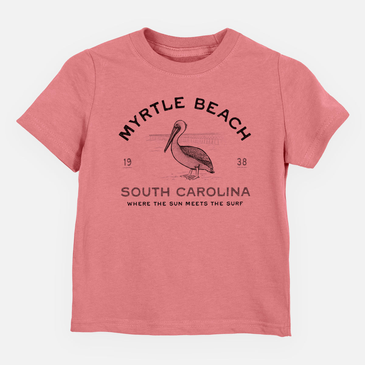 Mauve pink toddler t-shirt laid flat, printed with a black ink pelican on a post with the words Myrtle Beach South Carolina, Where the Sun Meets the Surf.
