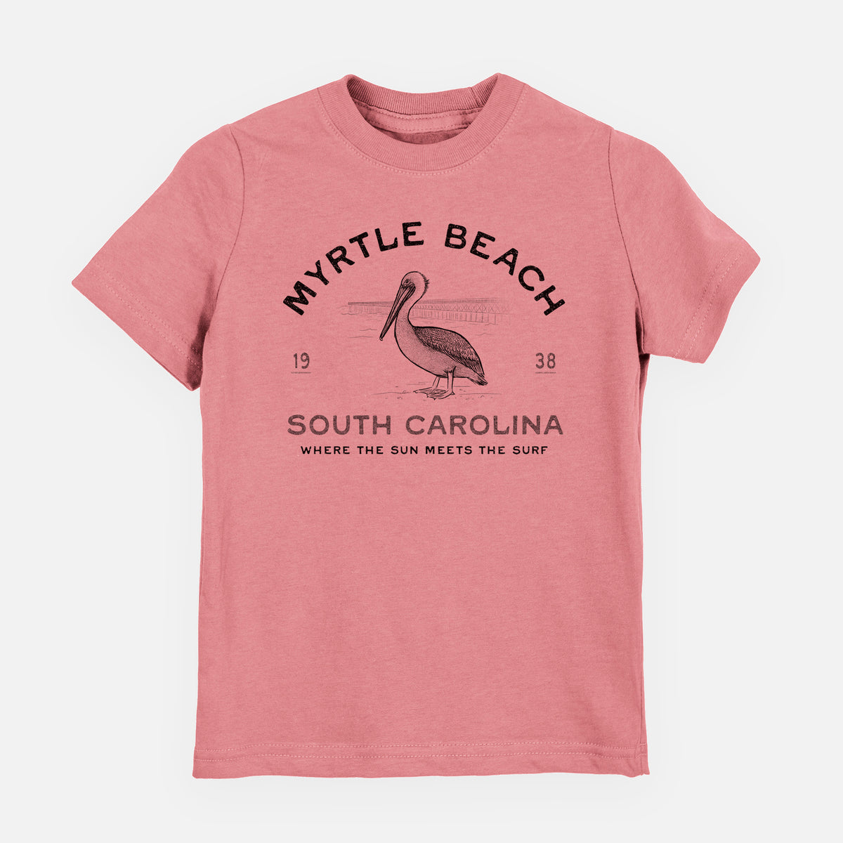 Mauve pink youth t-shirt laid flat, printed with a black ink pelican on a post with the words Myrtle Beach South Carolina, Where the Sun Meets the Surf.