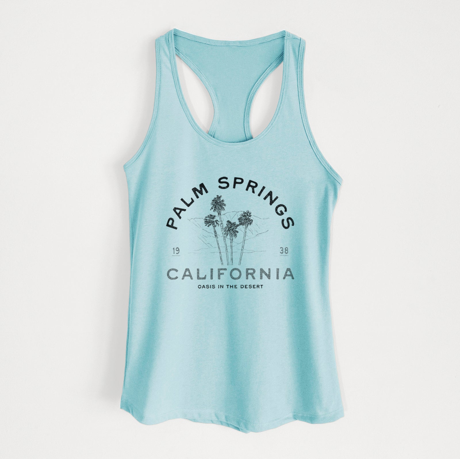 Banana cream women's racerback tank top laid flat, printed with black ink palm trees with the words Palm Springs California, 1938, Oasis in the Desert.