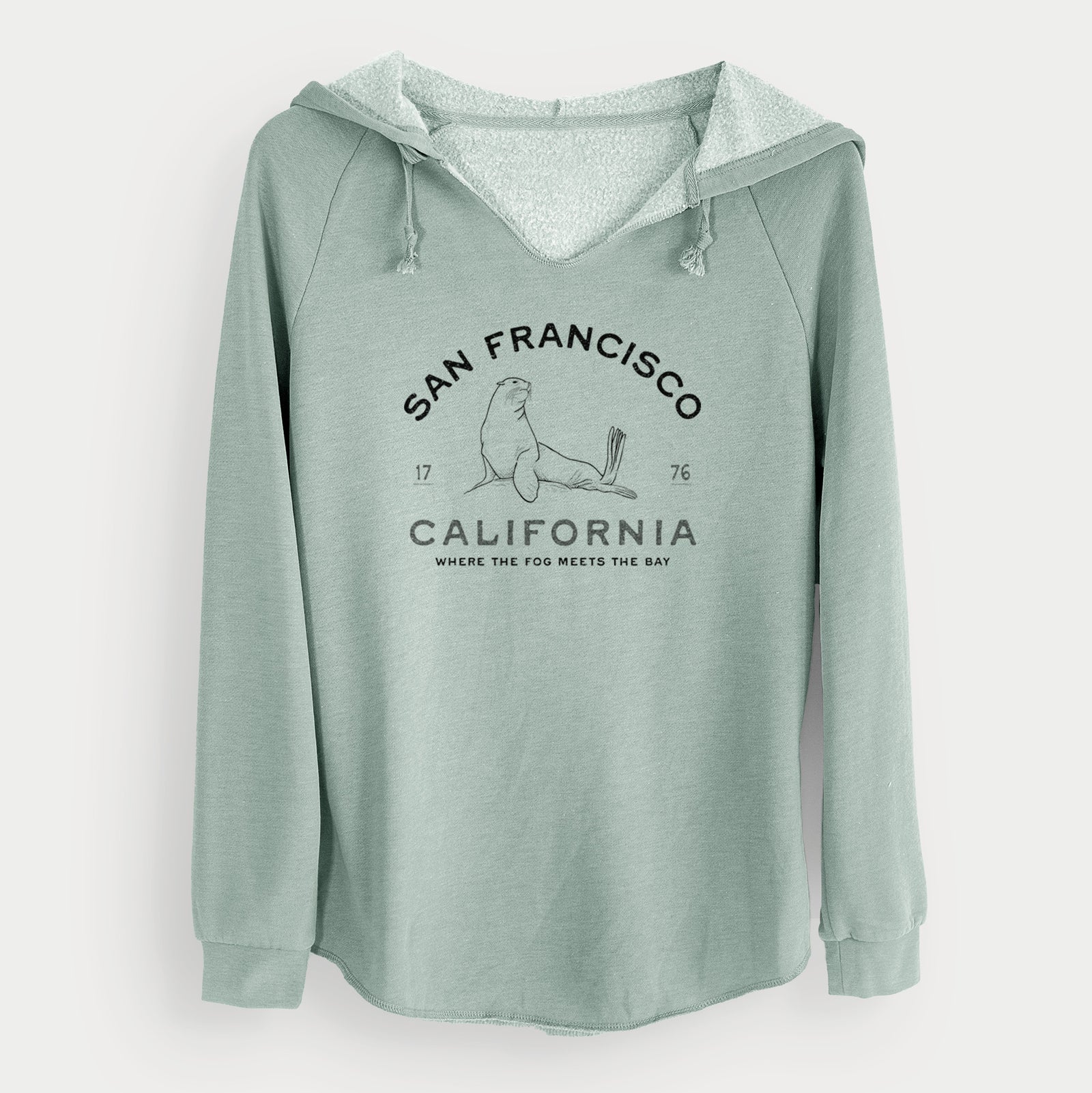 Sage green women's Cali Wave hooded sweatshirt laid flat, printed with a black ink sea lion with the words San Francisco California, 1776, Where the Fog Meets the Bay.
