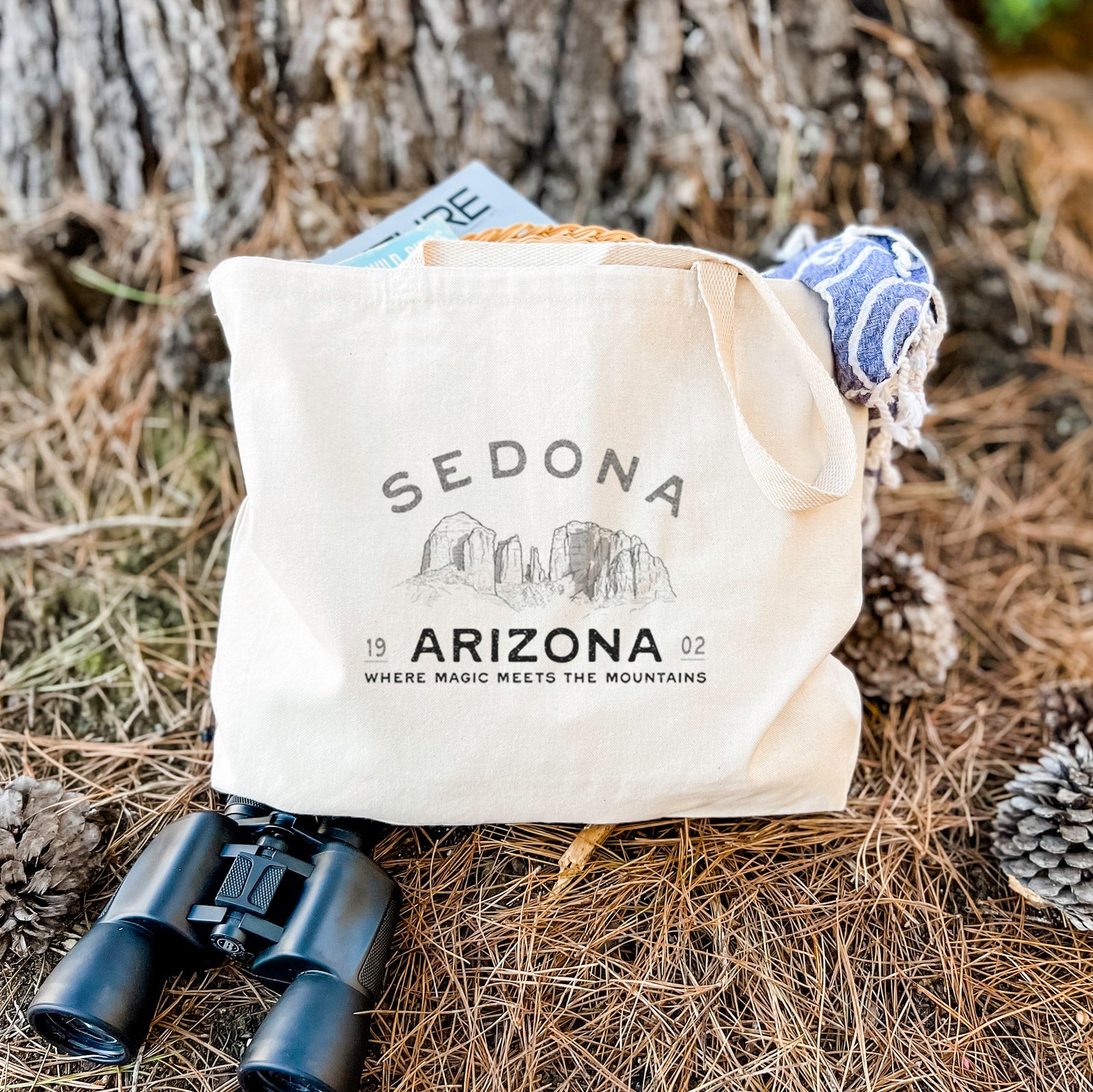 Natural canvas tote bag printed with black ink red rock buttes with the words Sedona Arizona, Where Magic Meets the Mountains.