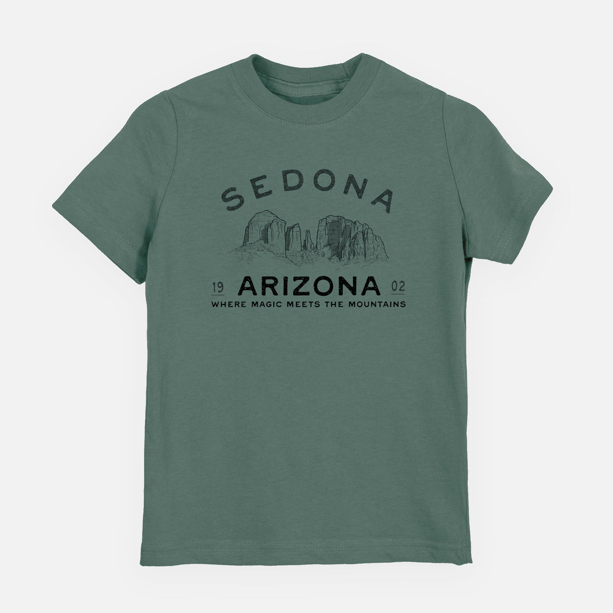 Basil green youth t-shirt laid flat, printed with black ink red rock buttes with the words Sedona Arizona, Where Magic Meets the Mountains.