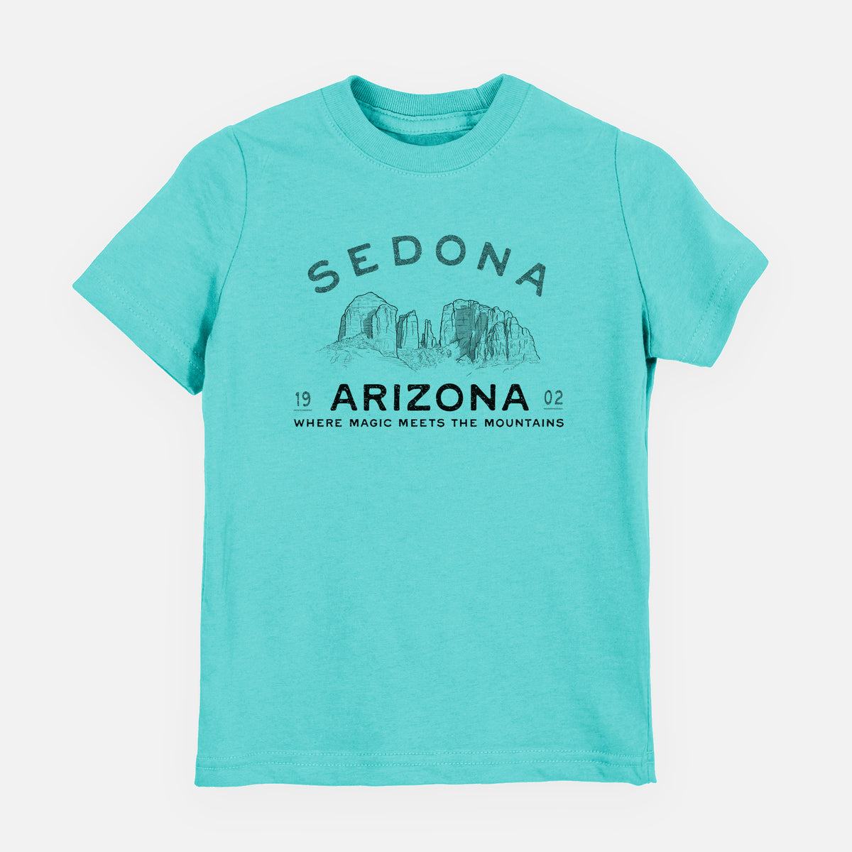 Caribbean blue youth t-shirt laid flat, printed with black ink red rock buttes with the words Sedona Arizona, Where Magic Meets the Mountains.