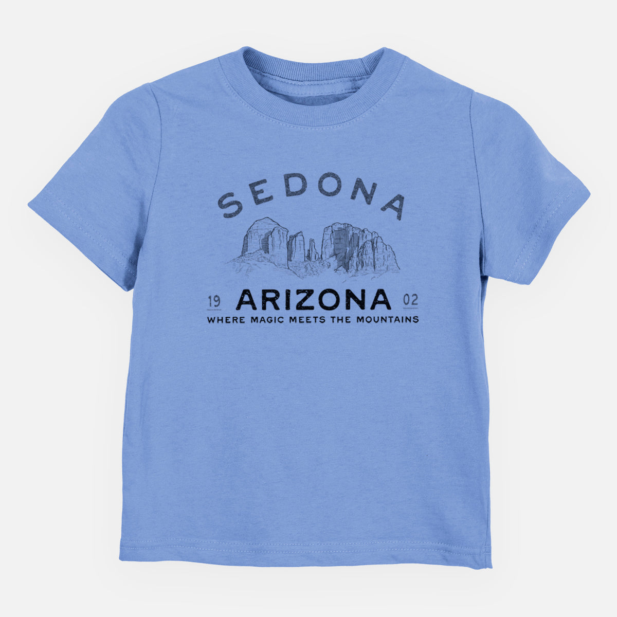Carolina blue toddler t-shirt laid flat, printed with black ink red rock buttes with the words Sedona Arizona, Where Magic Meets the Mountains.