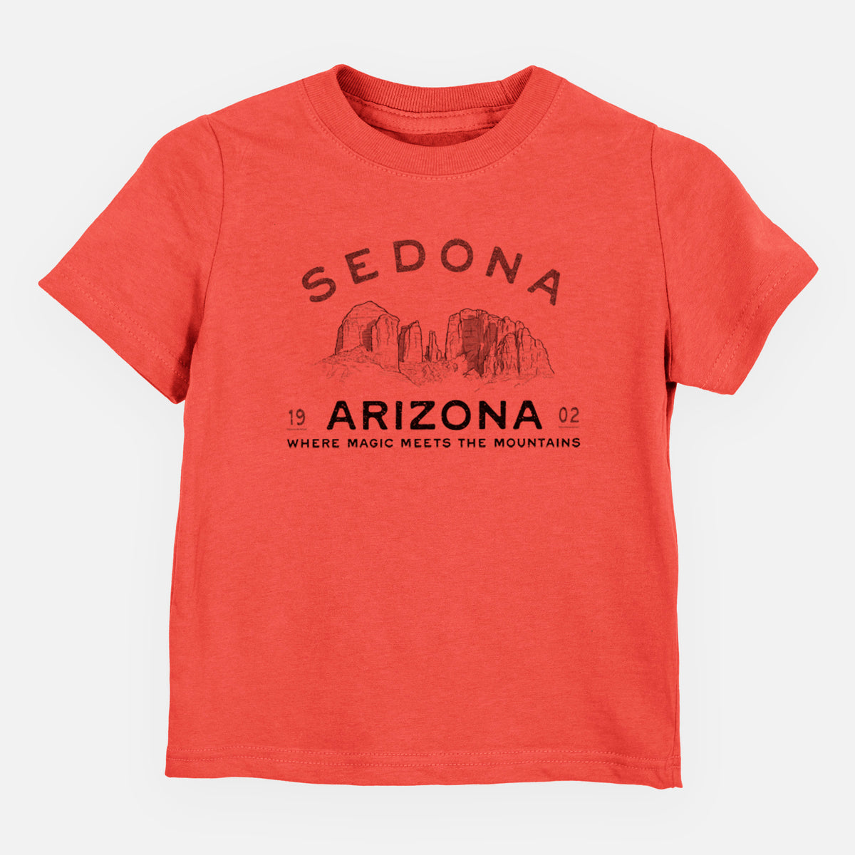 Passionfruit pink toddler t-shirt laid flat, printed with black ink red rock buttes with the words Sedona Arizona, Where Magic Meets the Mountains.