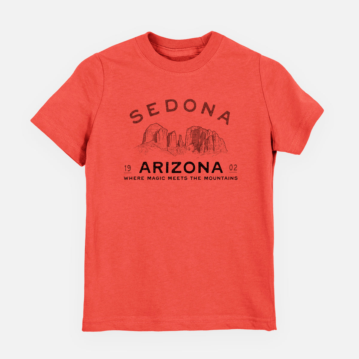 Passionfruit pink youth t-shirt laid flat, printed with black ink red rock buttes with the words Sedona Arizona, Where Magic Meets the Mountains.