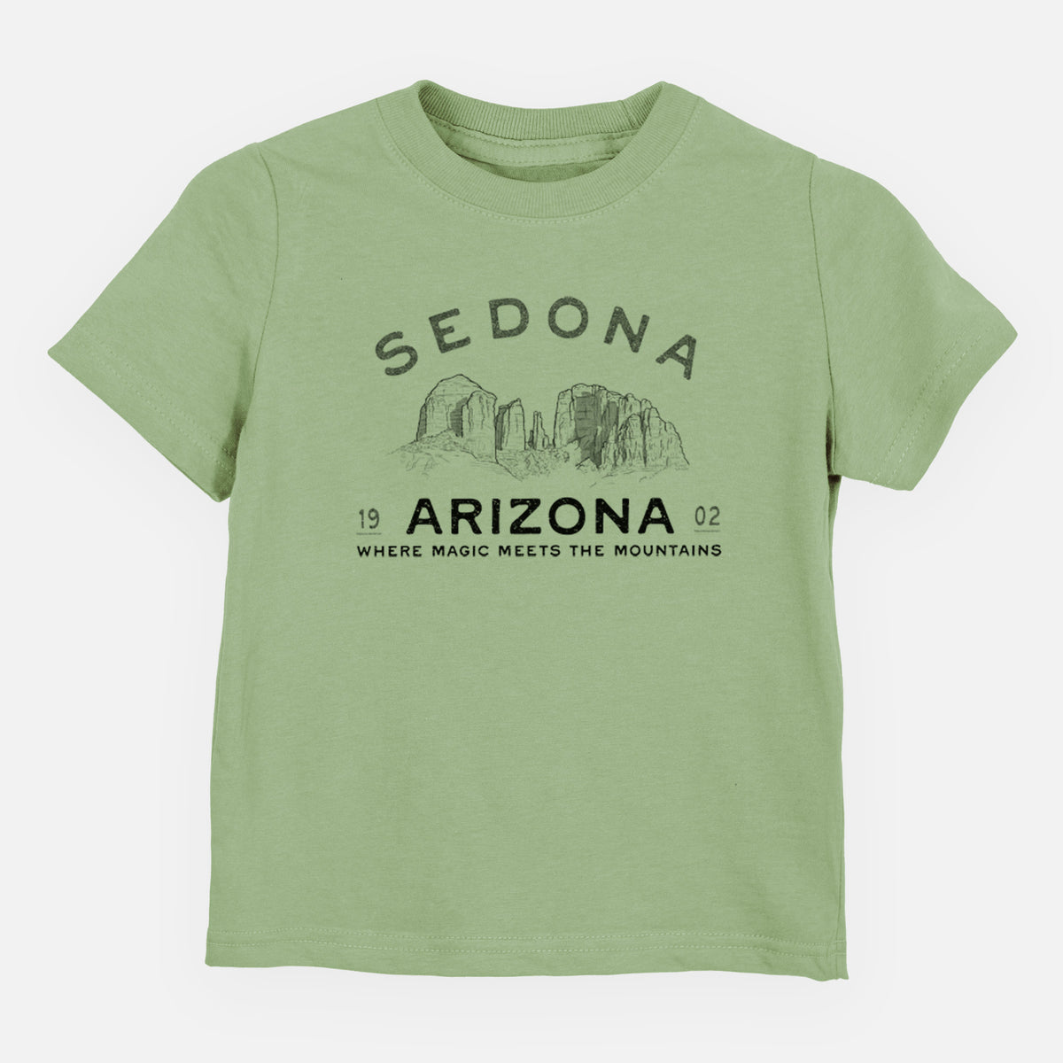 Sage green toddler t-shirt laid flat, printed with black ink red rock buttes with the words Sedona Arizona, Where Magic Meets the Mountains.