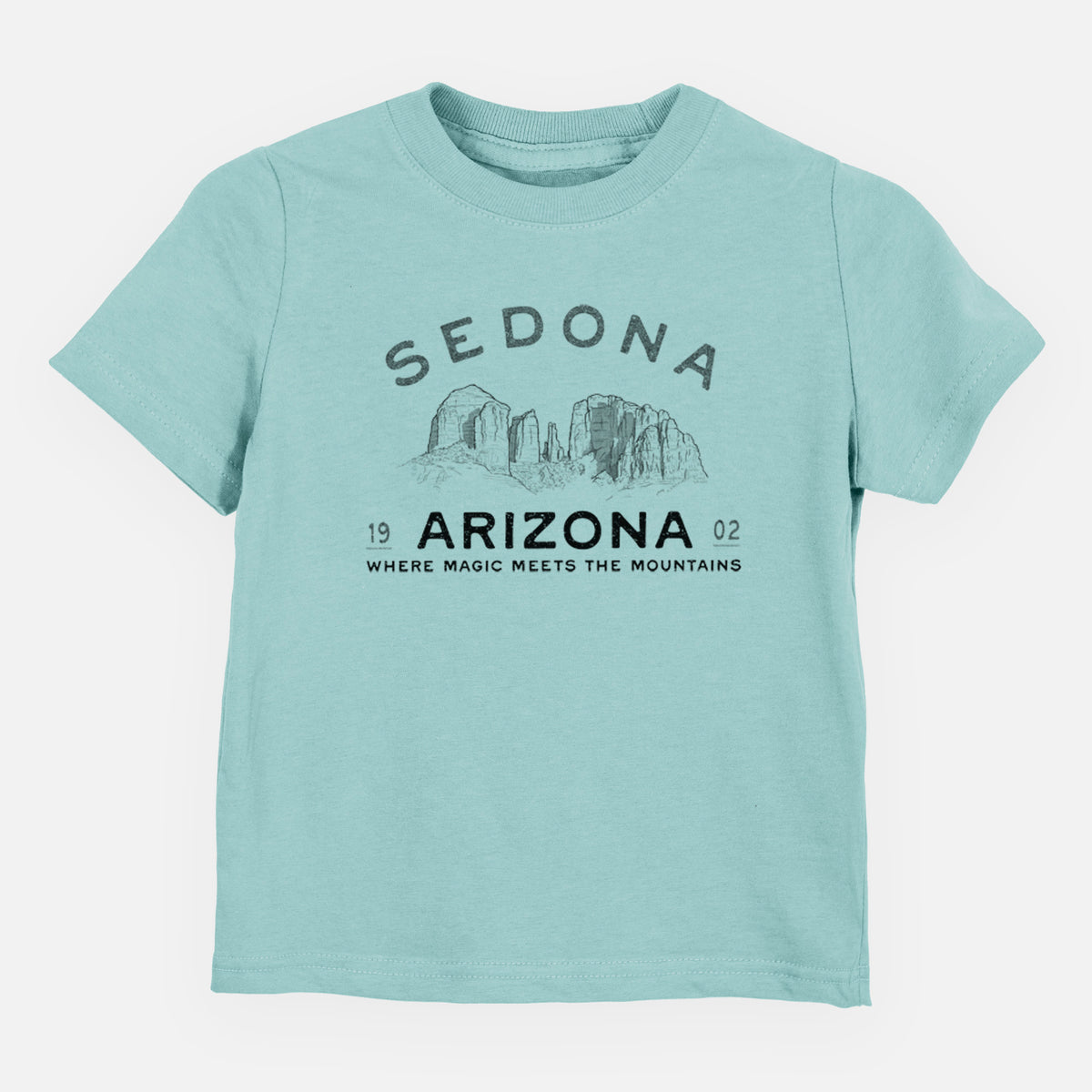 Saltwater toddler t-shirt laid flat, printed with black ink red rock buttes with the words Sedona Arizona, Where Magic Meets the Mountains.