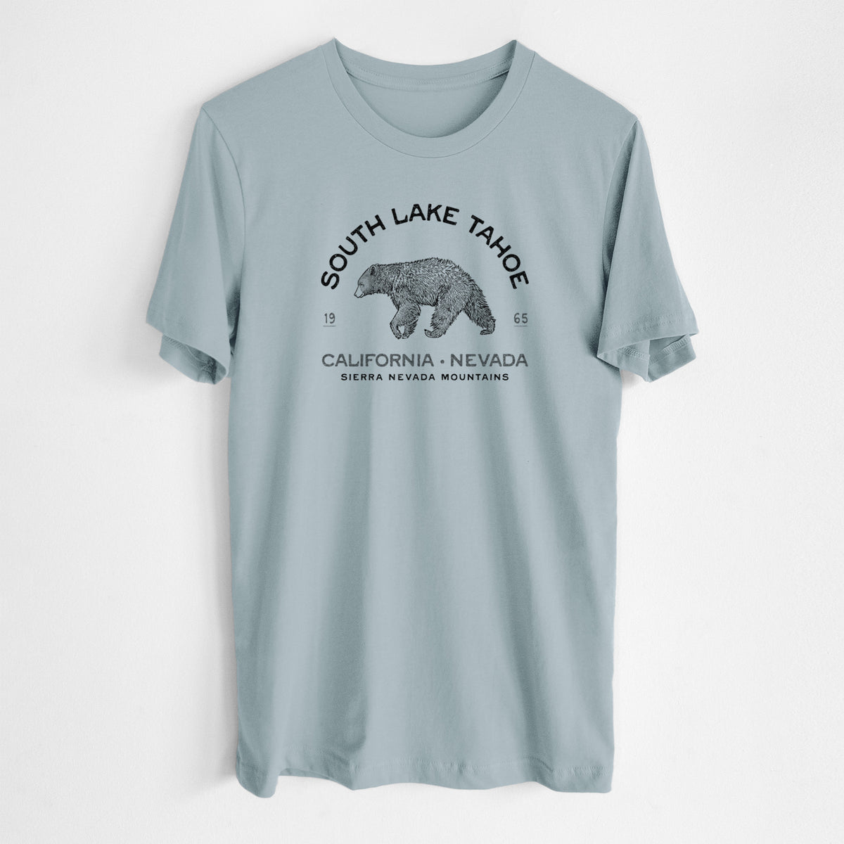 Vintage denim lightweight cotton t-shirt laid flat, printed with a black ink bear with the words South Lake Tahoe, California - Nevada, Sierra Nevada Mountains.