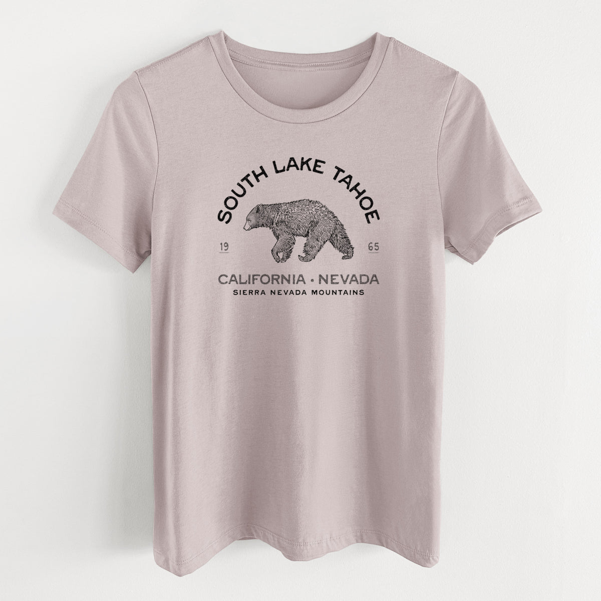 Pink gravel women's relaxed fit cotton t-shirt laid flat, printed with a black ink bear with the words South Lake Tahoe, California - Nevada, Sierra Nevada Mountains.