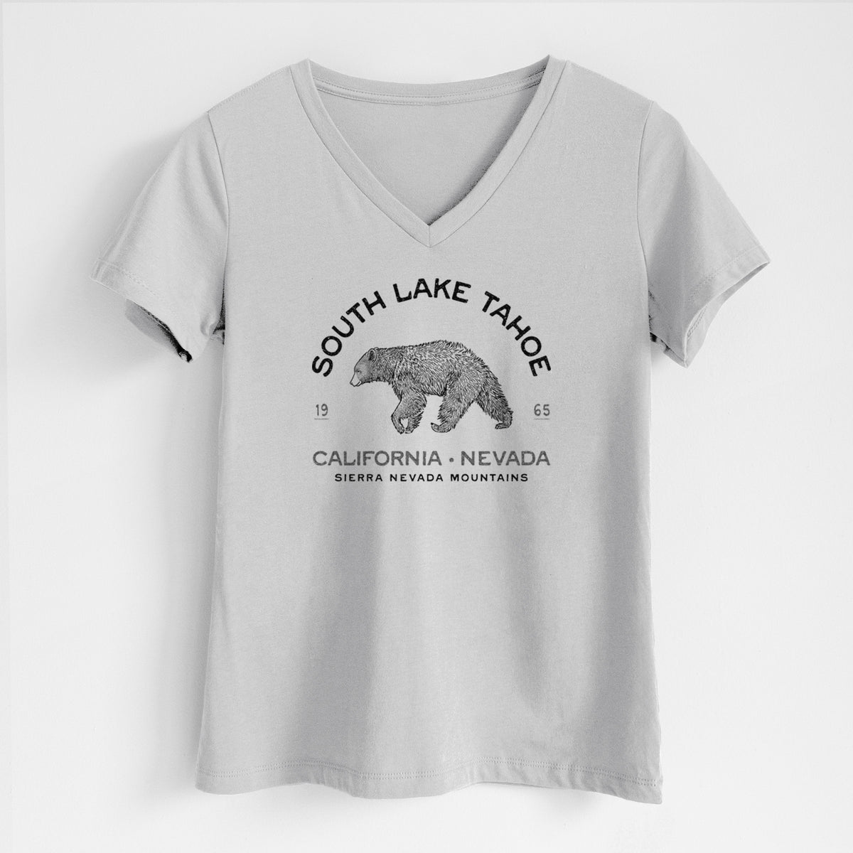 Lunar grey women's relaxed fit cotton V-neck t-shirt laid flat, printed with a black ink bear with the words South Lake Tahoe, California - Nevada, Sierra Nevada Mountains.