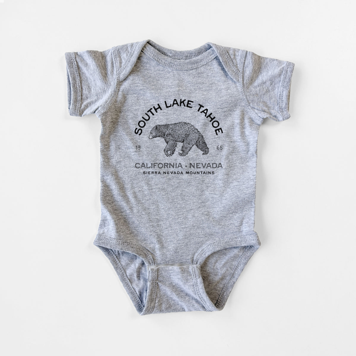 Grey baby bodysuit laid flat, printed with a black ink bear with the words South Lake Tahoe, California - Nevada, Sierra Nevada Mountains.