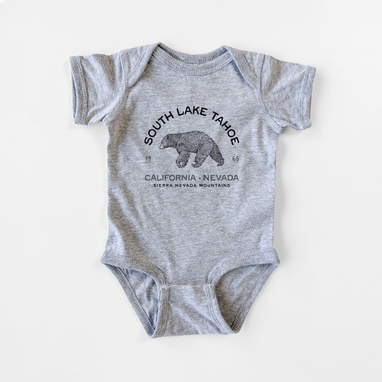 Grey baby bodysuit laid flat, printed with a black ink bear with the words South Lake Tahoe, California - Nevada, Sierra Nevada Mountains.