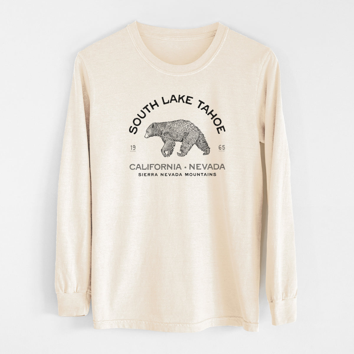 Ivory Comfort Colors long sleeve shirt laid flat, printed with a black ink bear with the words South Lake Tahoe, California - Nevada, Sierra Nevada Mountains.