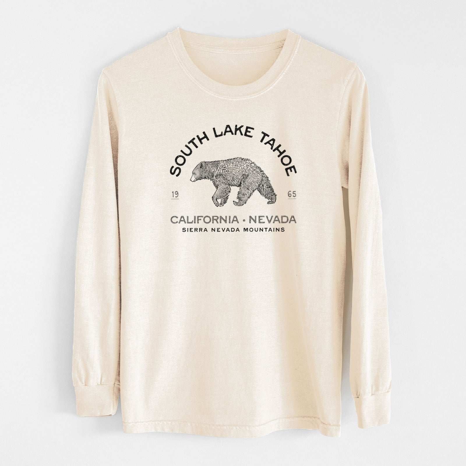 Ivory Comfort Colors long sleeve shirt laid flat, printed with a black ink bear with the words South Lake Tahoe, California - Nevada, Sierra Nevada Mountains.