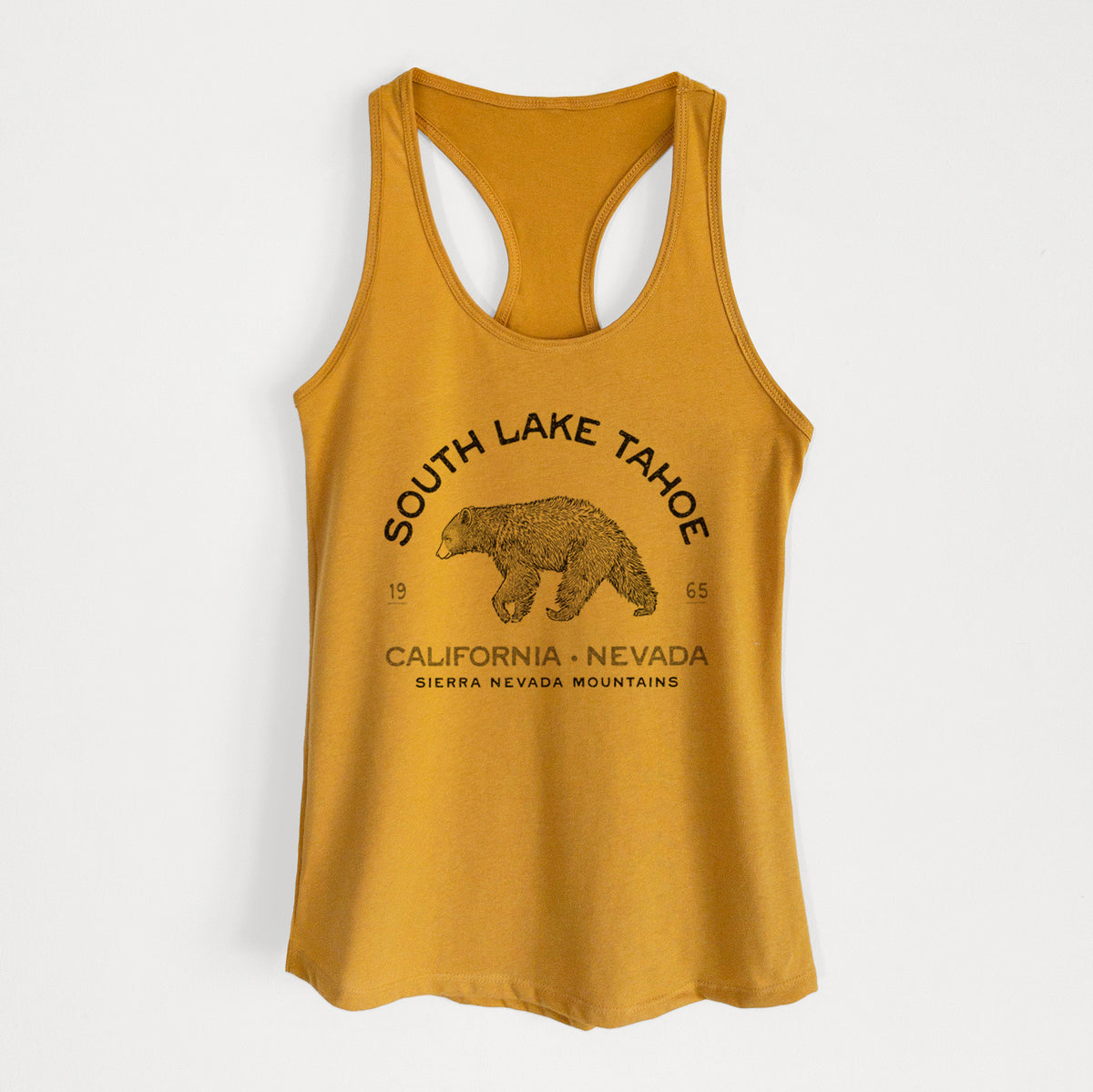 Gold women's racerback tank top laid flat, printed with a black ink bear with the words South Lake Tahoe, California - Nevada, Sierra Nevada Mountains.