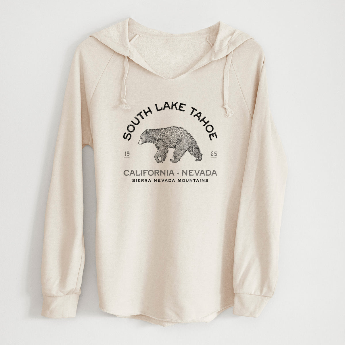 Bone cream women's Cali Wave hooded sweatshirt laid flat, printed with a black ink bear with the words South Lake Tahoe, California - Nevada, Sierra Nevada Mountains.