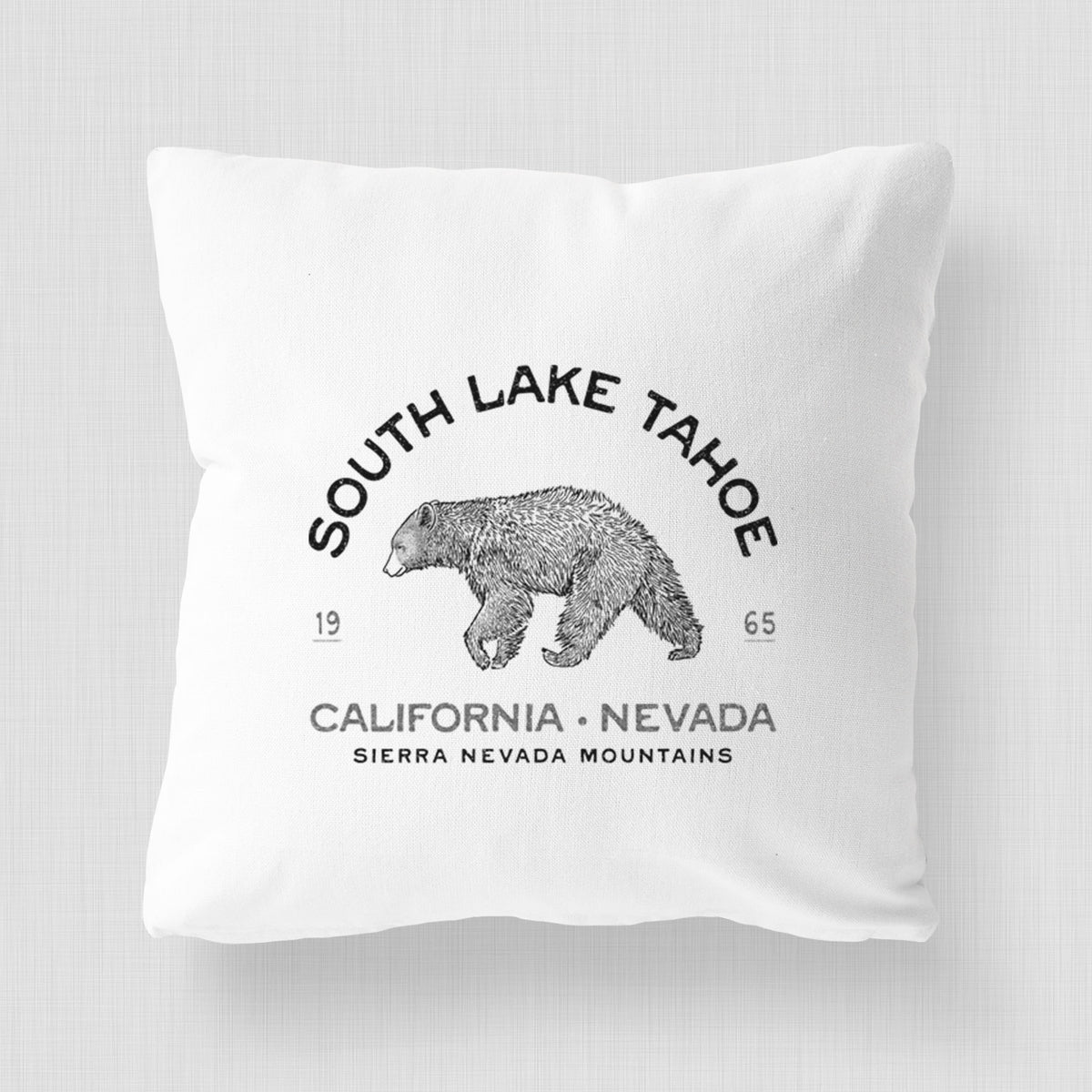 White pillow cover printed with a black ink bear with the words South Lake Tahoe, California - Nevada, Sierra Nevada Mountains.