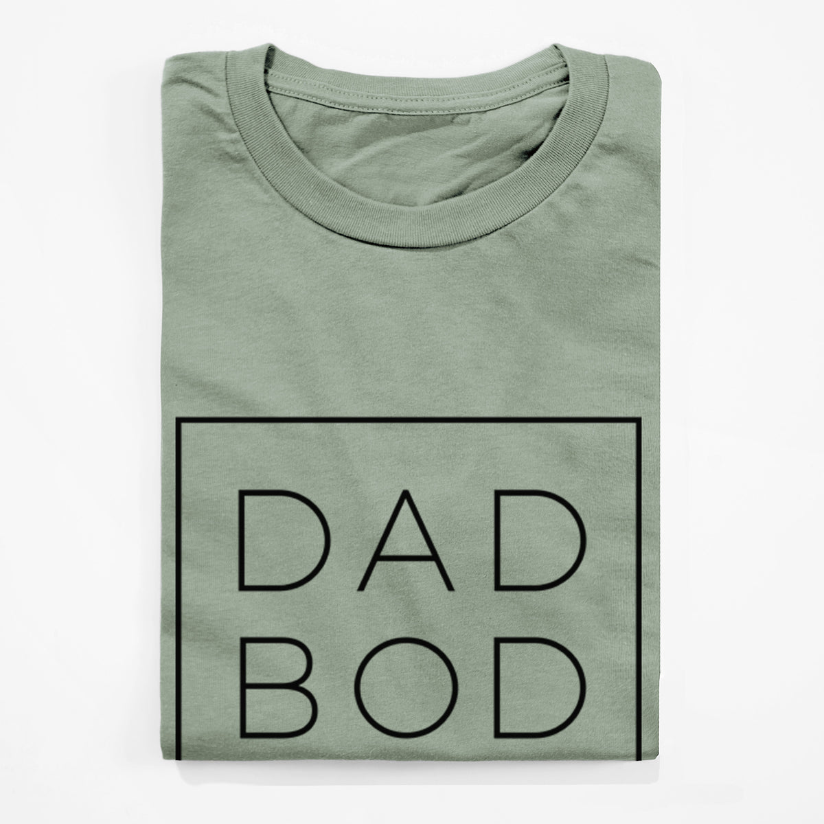 Sage green lightweight cotton t-shirt folded, showing the words DAD BOD in thin black letters stacked inside a square outline.