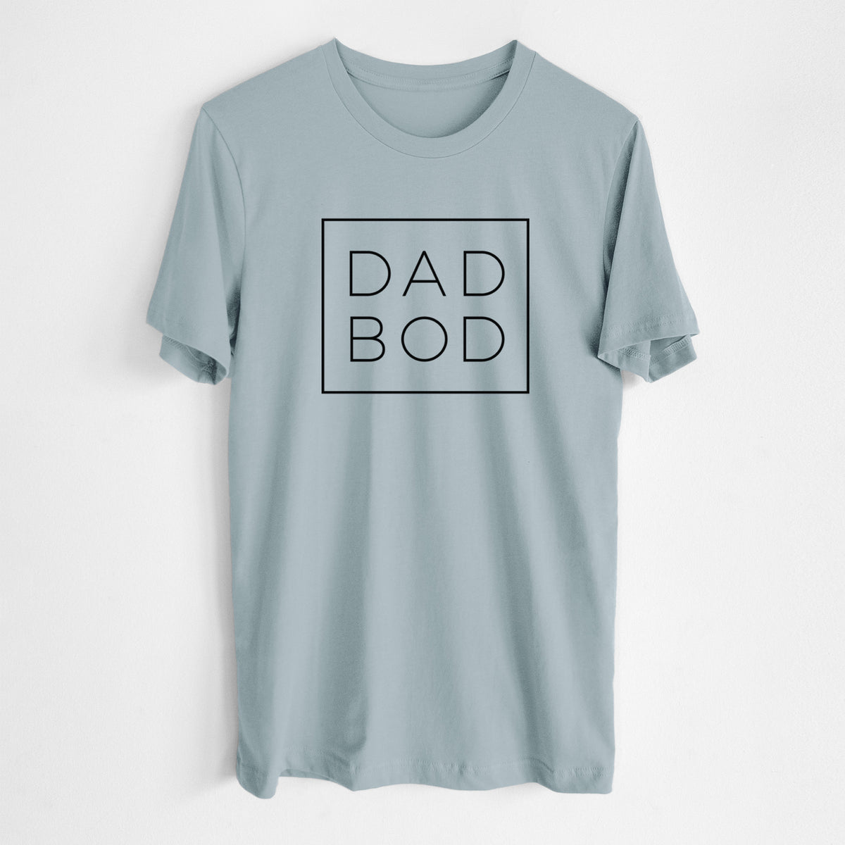 Vintage denim lightweight cotton t-shirt laid flat, printed with the words DAD BOD in thin black letters stacked inside a square outline.