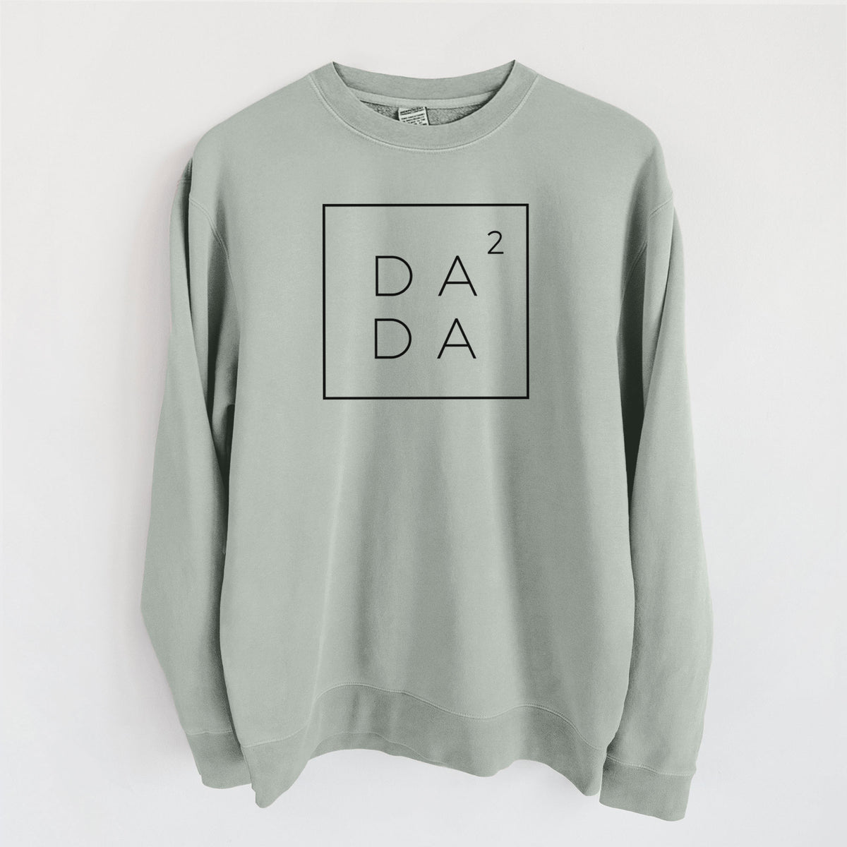 Sage green pigment dyed crewneck sweatshirt laid flat, printed with the word DADA stacked inside a square outline with a small squared symbol, for a dad of two.