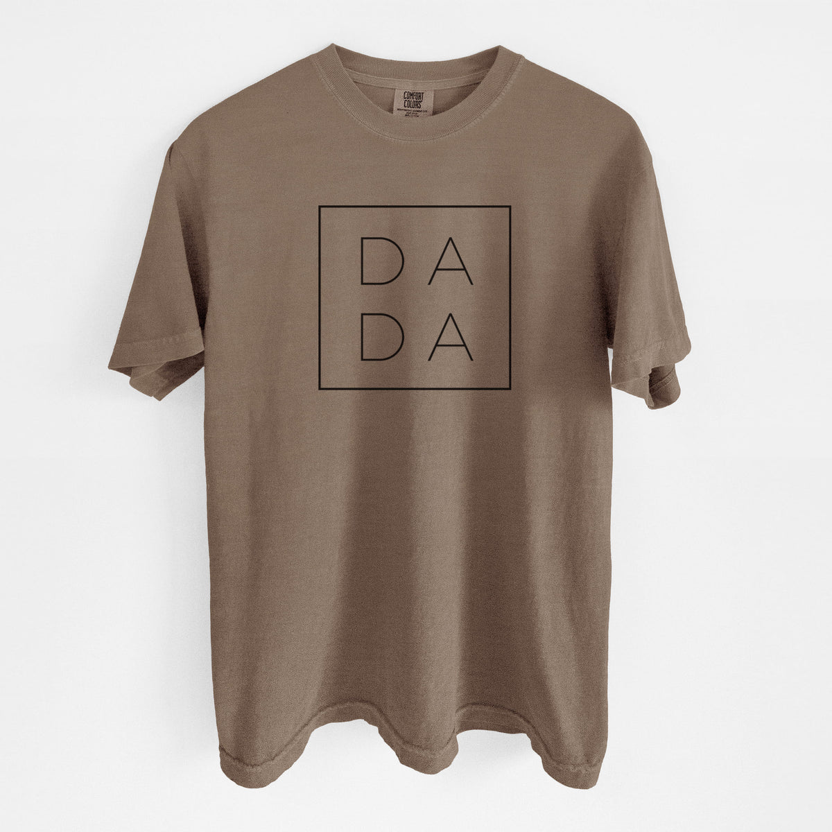 Espresso brown Comfort Colors t-shirt laid flat, printed with the word DADA in thin black letters stacked inside a square outline.