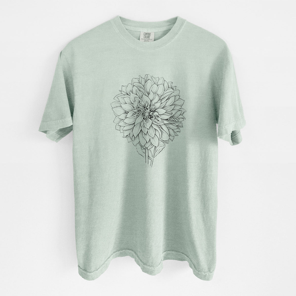Bay green Comfort Colors t-shirt laid flat, printed with a detailed black ink line drawing of a Cafe au Lait dahlia bloom.
