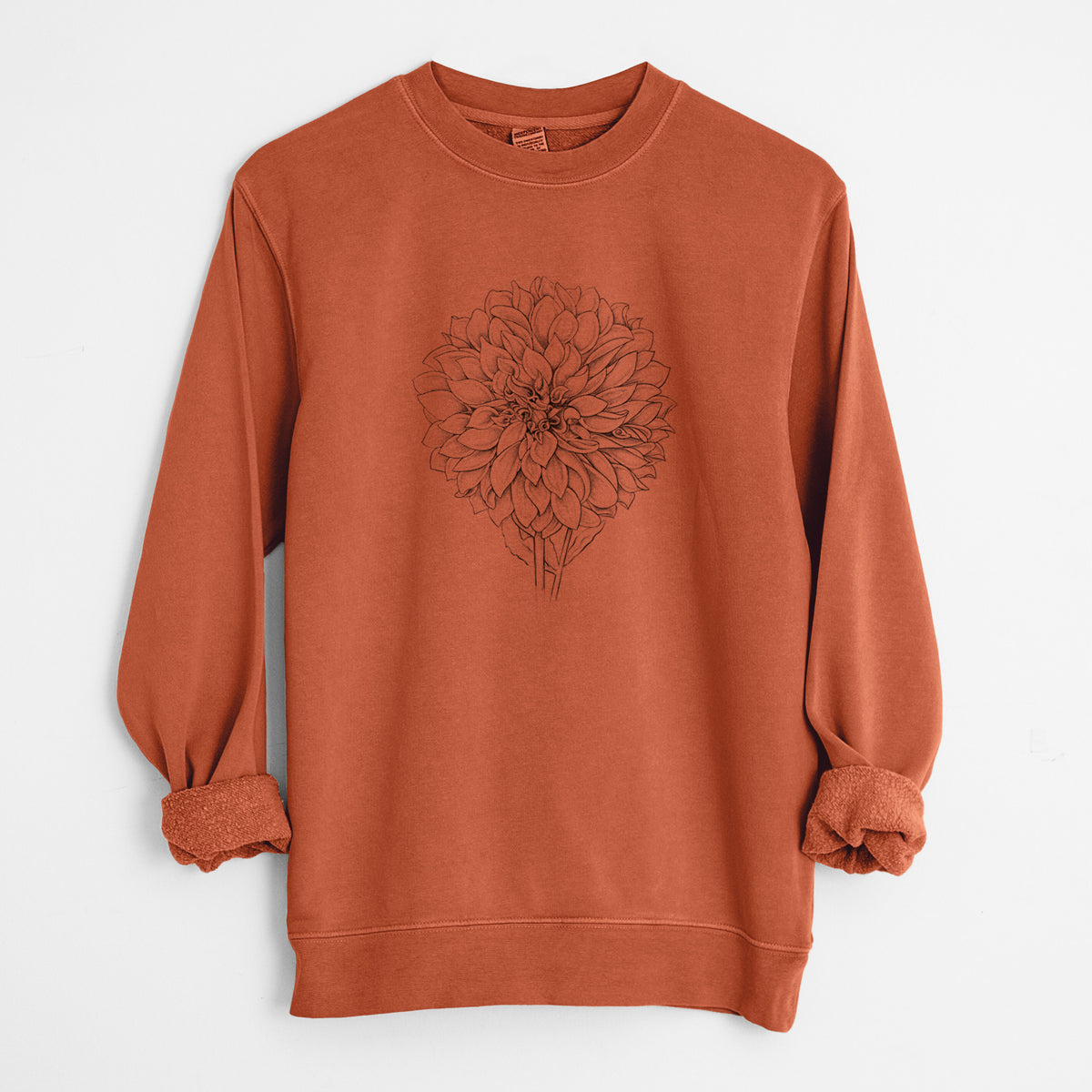 Amber orange pigment dyed crewneck sweatshirt laid flat with the sleeves rolled, printed with a detailed black ink line drawing of a Cafe au Lait dahlia bloom.