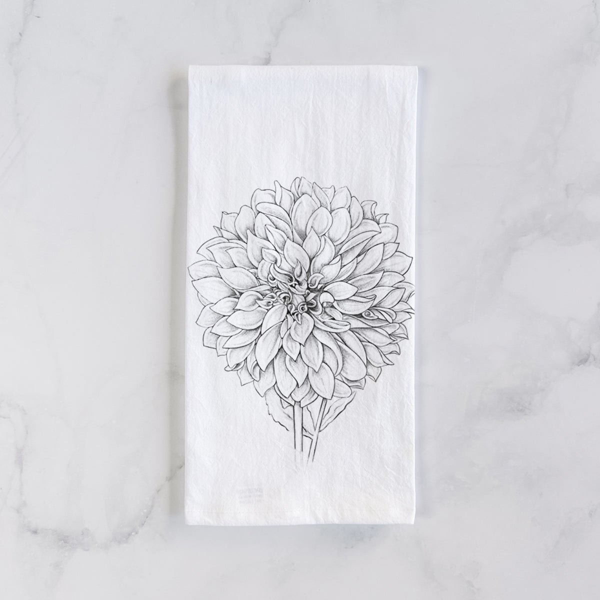 White cotton tea towel laid flat on marble, printed with a detailed black ink line drawing of a Cafe au Lait dahlia bloom.