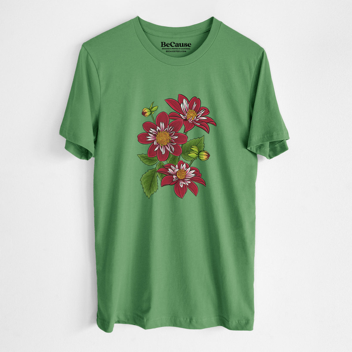 Leaf green lightweight cotton t-shirt laid flat, printed with a full-color illustration of deep red dahlia flowers with green leaves and a small bee.