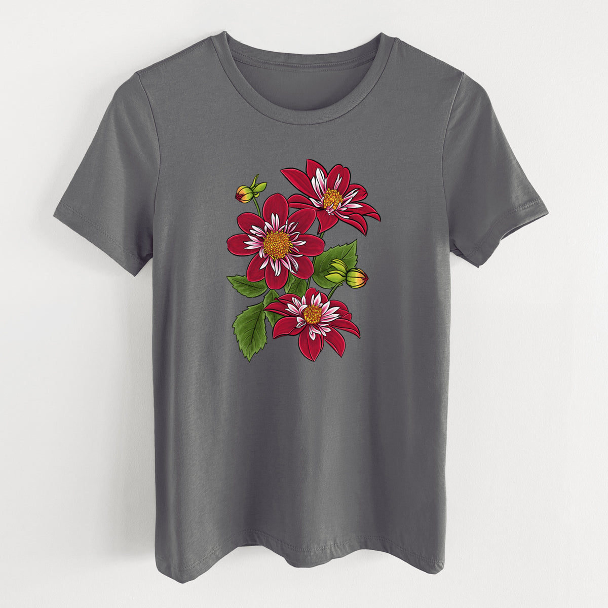 Asphalt women's relaxed fit cotton t-shirt laid flat, printed with a full-color illustration of deep red dahlia flowers with green leaves and a small bee.