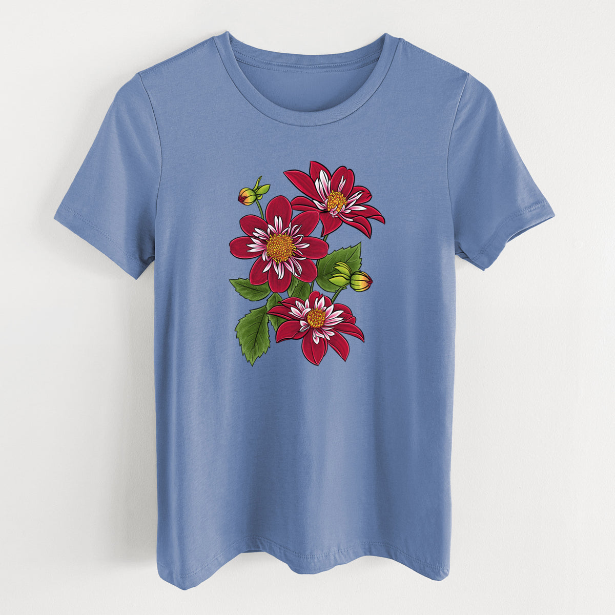 Blue bell women's relaxed fit cotton t-shirt laid flat, printed with a full-color illustration of deep red dahlia flowers with green leaves and a small bee.