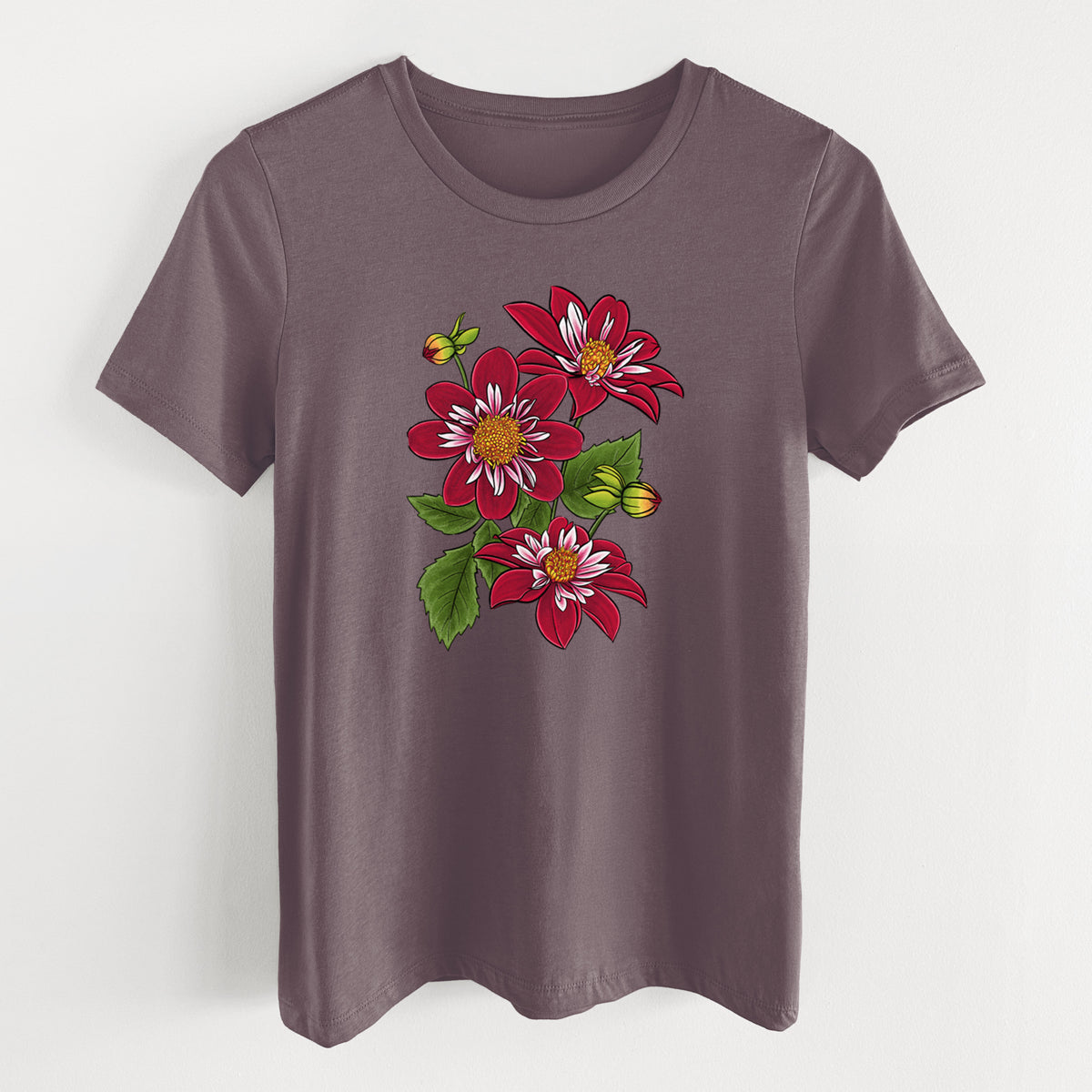 Purple storm women's relaxed fit cotton t-shirt laid flat, printed with a full-color illustration of deep red dahlia flowers with green leaves and a small bee.