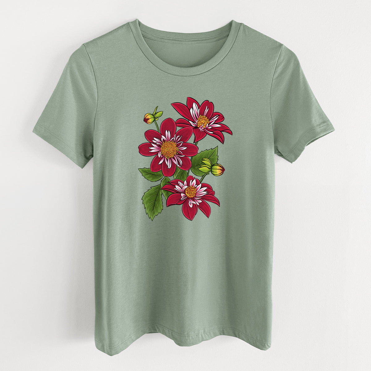 Sage green women's relaxed fit cotton t-shirt laid flat, printed with a full-color illustration of deep red dahlia flowers with green leaves and a small bee.