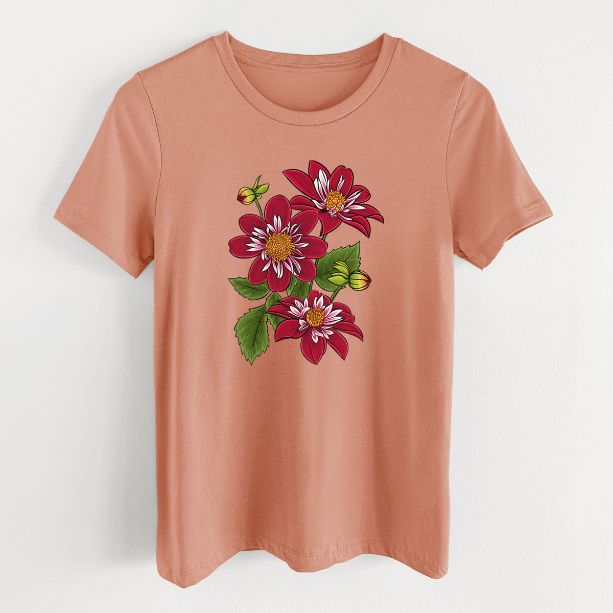 Terracotta orange women's relaxed fit cotton t-shirt laid flat, printed with a full-color illustration of deep red dahlia flowers with green leaves and a small bee.