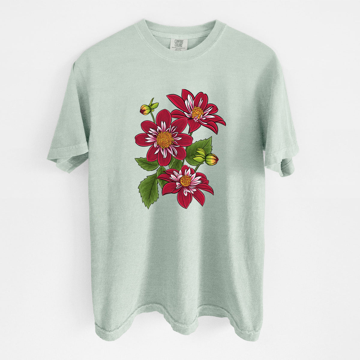 Bay green Comfort Colors t-shirt laid flat, printed with a full-color illustration of deep red dahlia flowers with green leaves and a small bee.