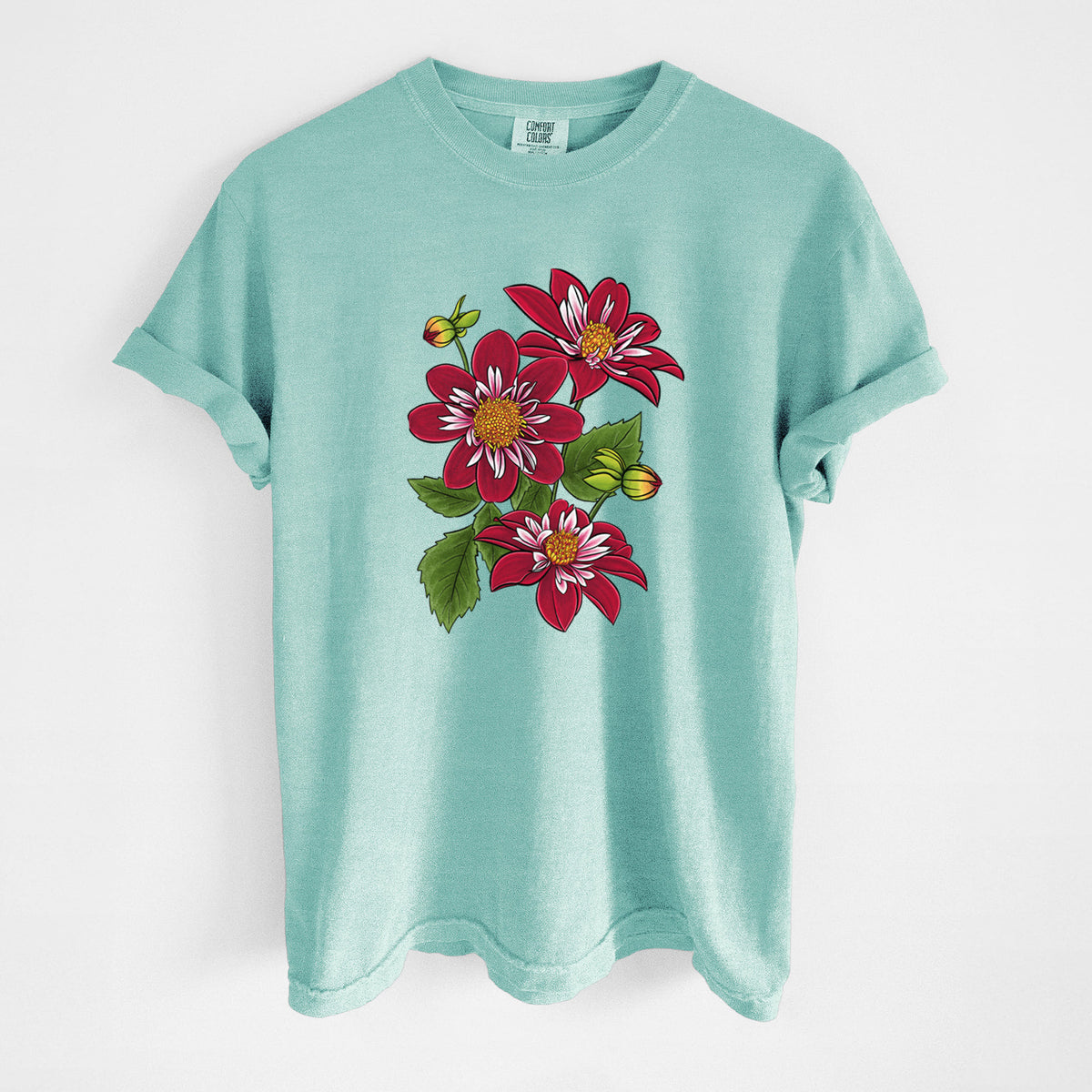 Chalky mint Comfort Colors t-shirt laid flat, printed with a full-color illustration of deep red dahlia flowers with green leaves and a small bee.