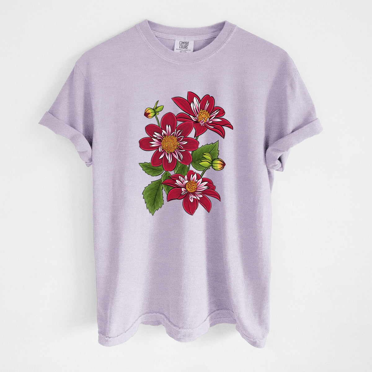 Orchid purple Comfort Colors t-shirt laid flat, printed with a full-color illustration of deep red dahlia flowers with green leaves and a small bee.