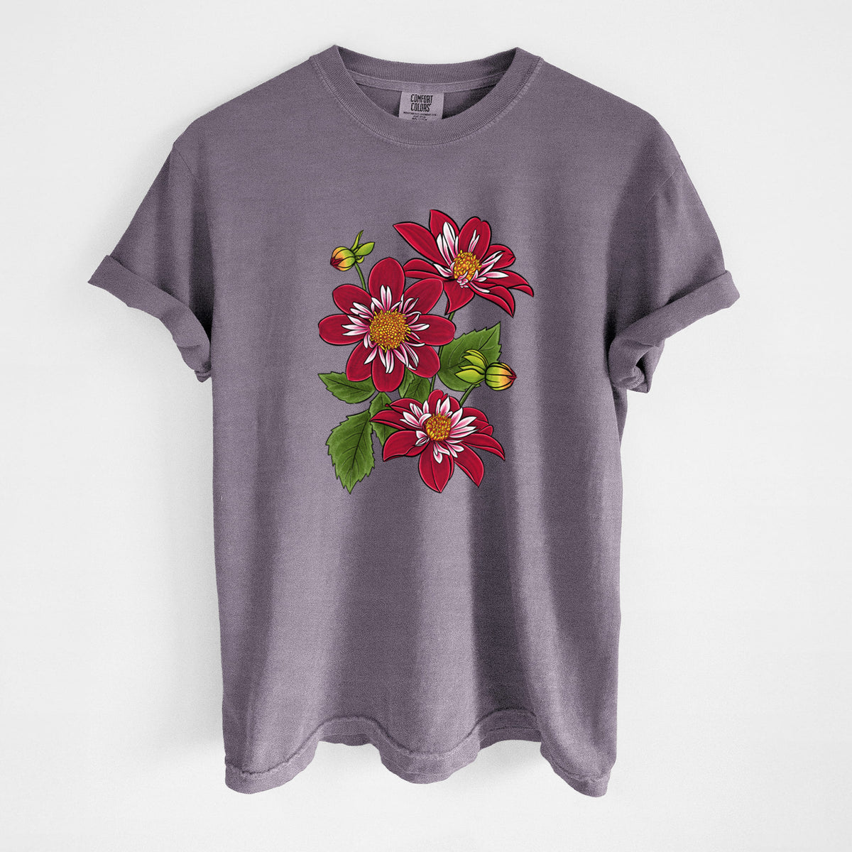 Wine red Comfort Colors t-shirt laid flat, printed with a full-color illustration of deep red dahlia flowers with green leaves and a small bee.