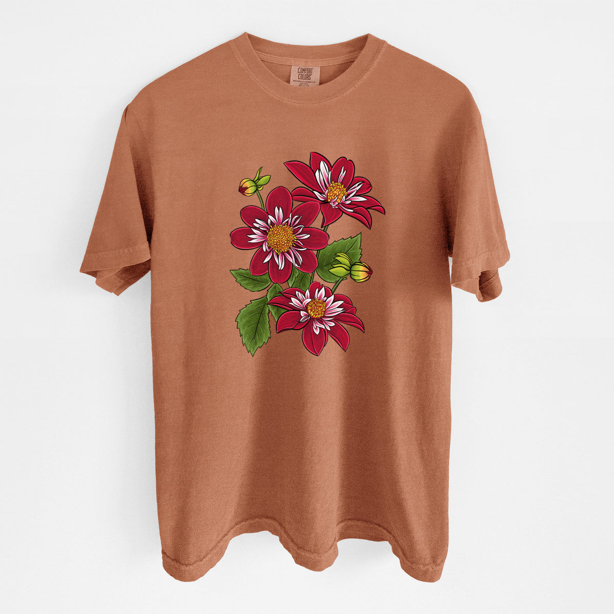 Yam burnt orange Comfort Colors t-shirt laid flat, printed with a full-color illustration of deep red dahlia flowers with green leaves and a small bee.