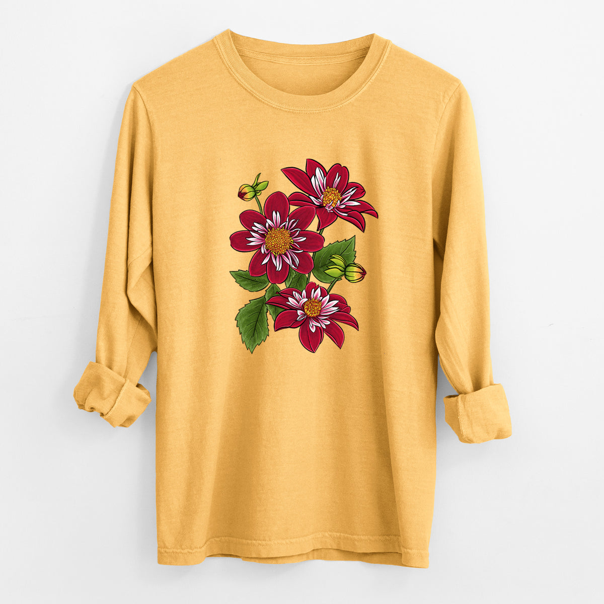 Golden wheat yellow Comfort Colors long sleeve shirt laid flat with the cuffs rolled, printed with a full-color illustration of deep red dahlia flowers with green leaves and a small bee.