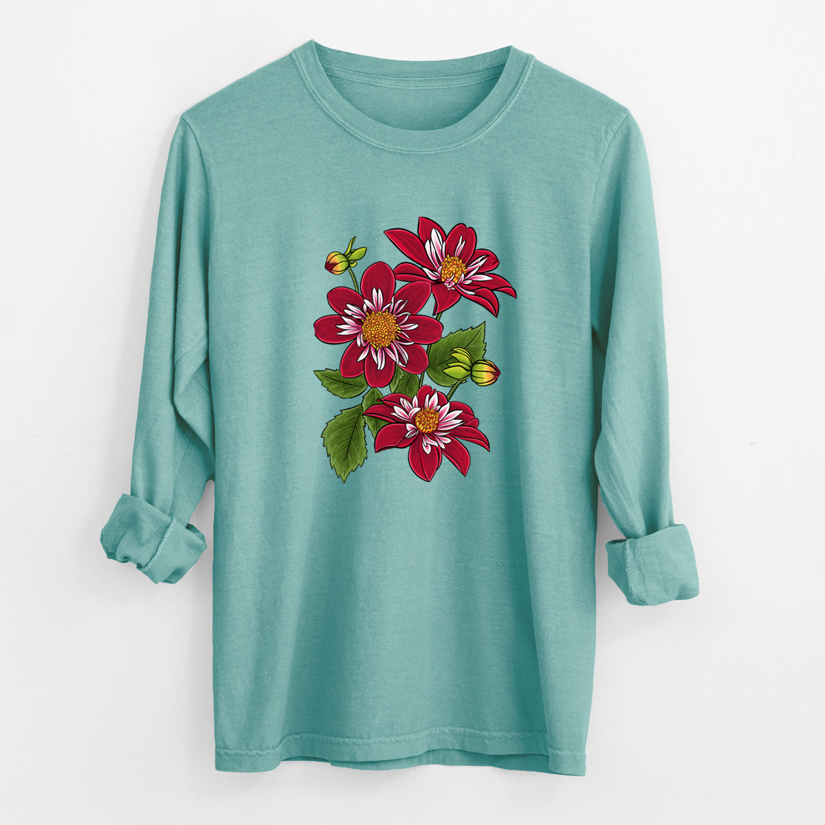 Reef green Comfort Colors long sleeve shirt laid flat with the cuffs rolled, printed with a full-color illustration of deep red dahlia flowers with green leaves and a small bee.